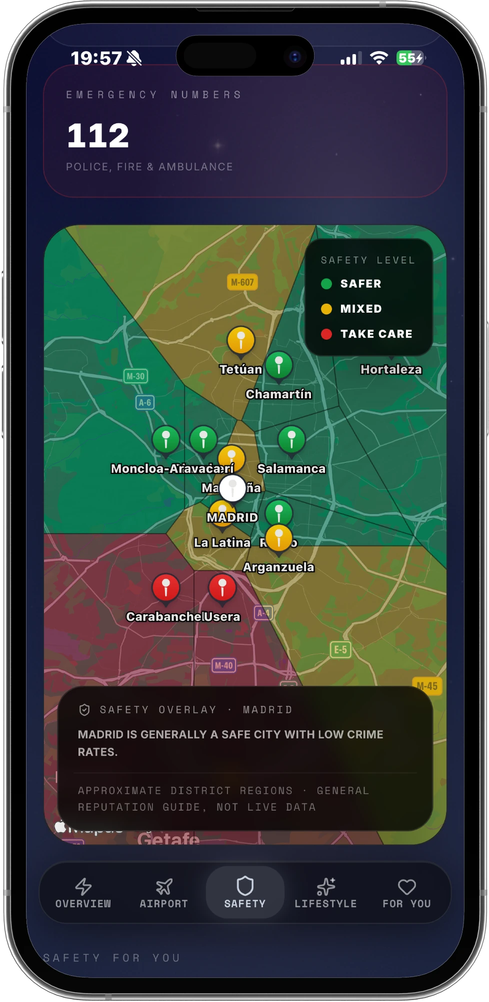 A safety overlay for Madrid: districts shaded green, amber and red with pins, the local emergency number 112 at the top, and a caption noting the regions are approximate and not live data.